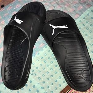 Black and white Puma slides